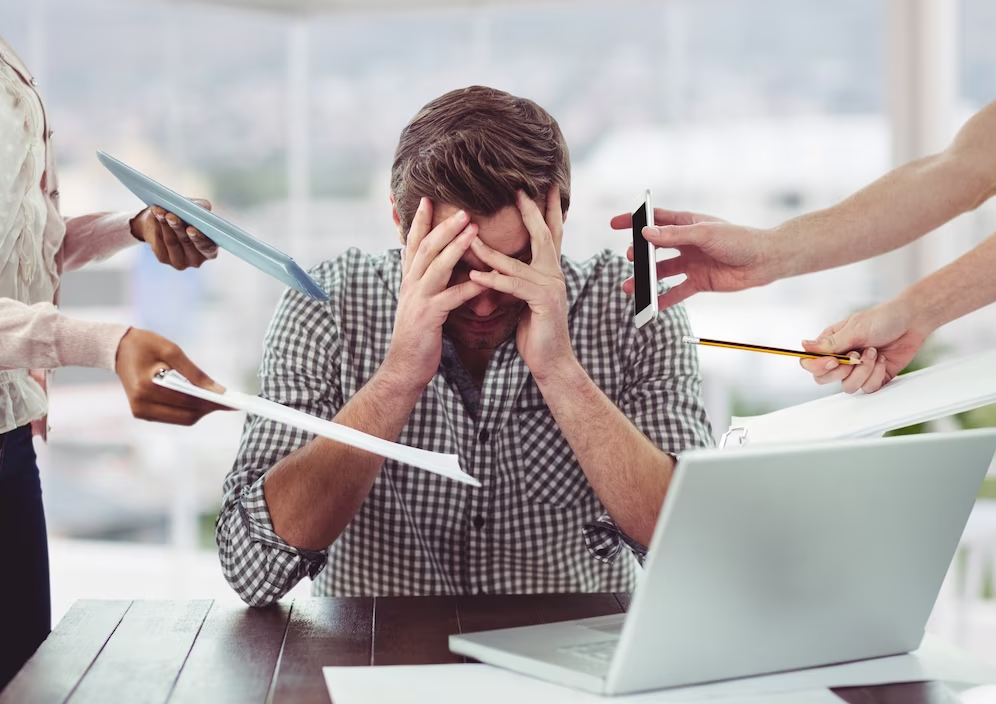 Homem sobrecarregado em trabalho